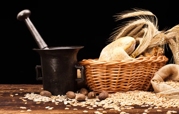 Baked bread, wheat and brass mortar — Stock Photo, Image