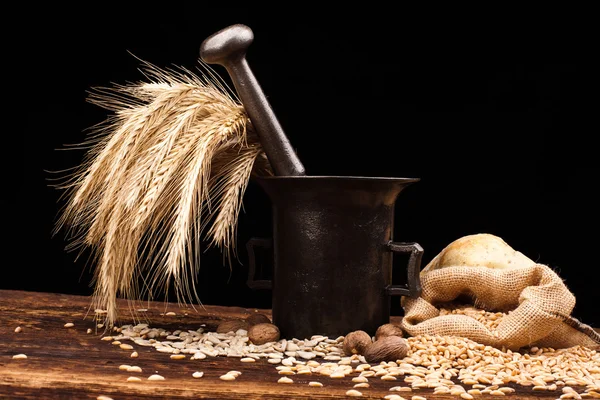 Baked bread, wheat and brass mortar — Stock Photo, Image