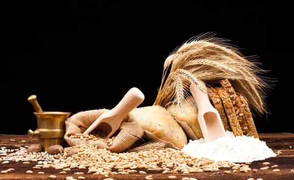 Baked bread, wheat and brass mortar — Stock Photo, Image