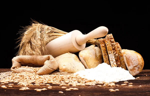 Baked bread on wooden table — Stock Photo, Image