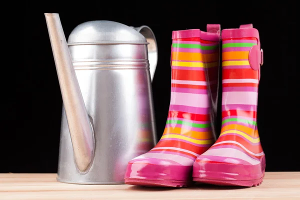 Rubber boots and watering can — Stockfoto
