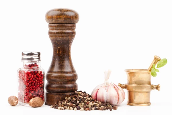 Wooden salt shaker and brass mortar with spices — Stock Photo, Image