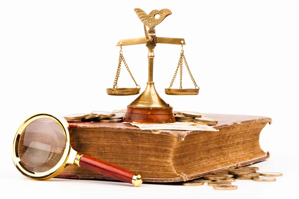 Law book, money, magnifying glass and scales of justice — Stock Photo, Image