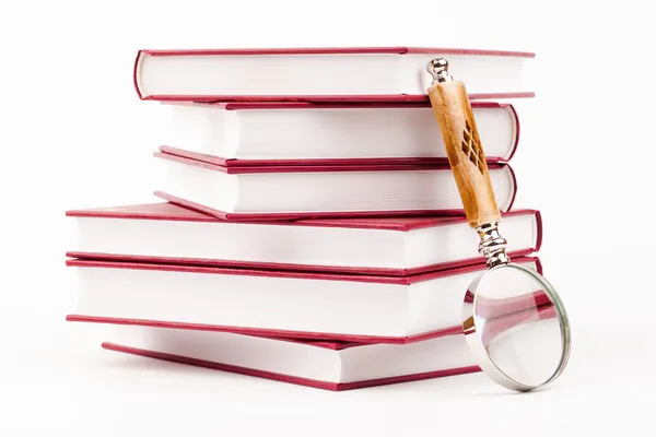 Books and magnifying glass — Stock Photo, Image