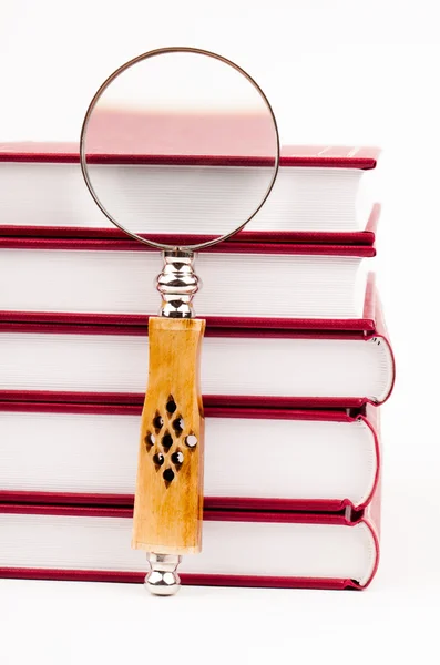 Books and magnifying glass — Stock Photo, Image