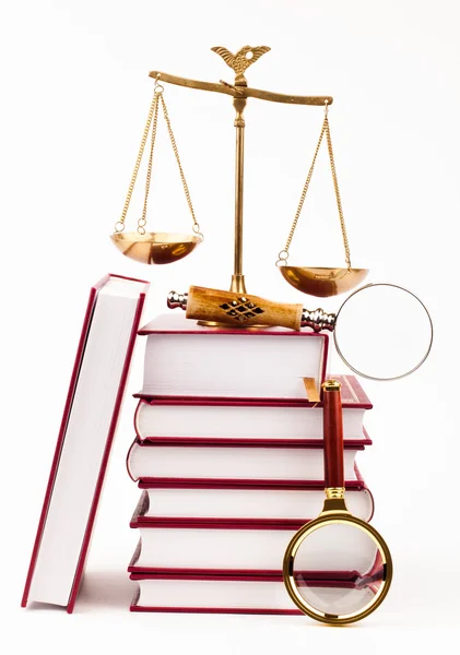 Law book, magnifying glass and scales of justice — Stock Photo, Image