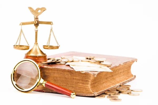 Law book, money, magnifying glass and scales of justice — Stock Photo, Image