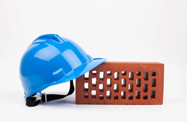 Hardhat and brick — Stock Photo, Image