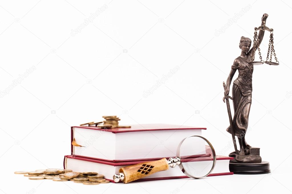 Law book, magnifying glass and lady of justice