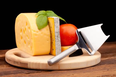 Tahta masada çeşitli peynir türleri var.