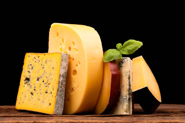 Various types of cheese on wooden table — Stock Photo, Image