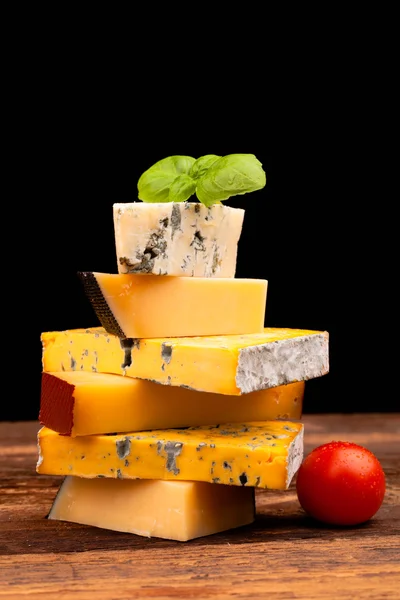 Various types of cheese isolated on black — Stock Photo, Image