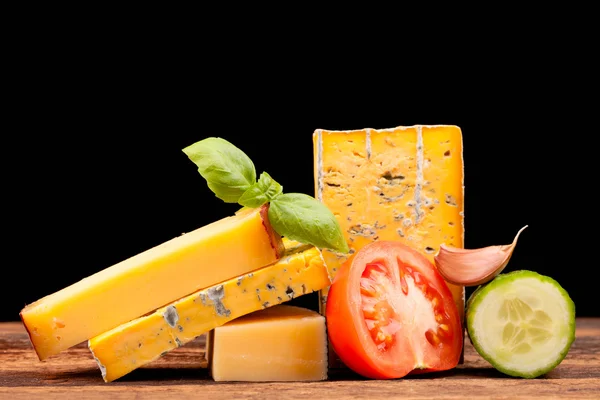 Various types of cheese isolated on black — Stock Photo, Image