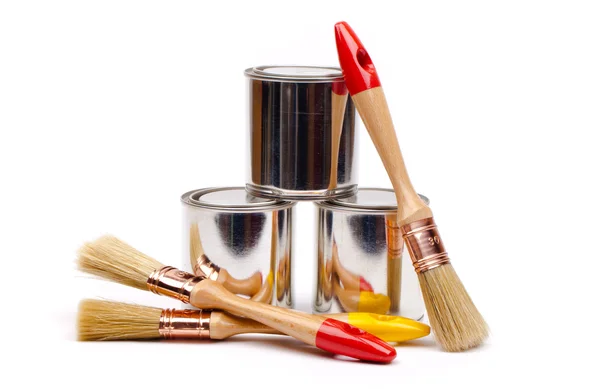 Cans of paint with paintbrushes — Stock Photo, Image