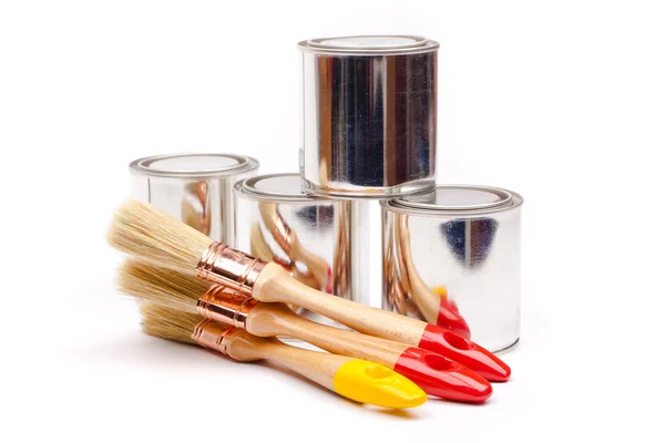 Cans of paint with paintbrushes — Stock Photo, Image