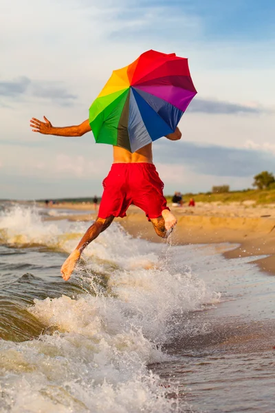 Happy man jumping on the beach — Stock Photo, Image