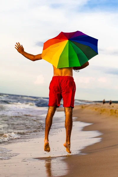 Happy man jumping on the beach — Stock Photo, Image