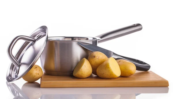 Potatoes and stainless pot — Stock Photo, Image