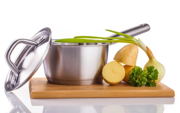 Potatoes and stainless pot — Stock Photo, Image