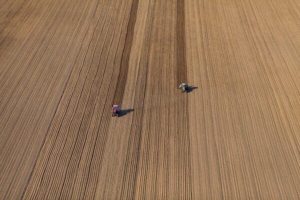 Aerial view of harvest fields with tractor