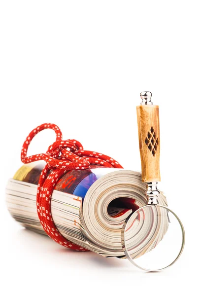Role of newspapers with red rope and magnyfying glass — Stock Photo, Image