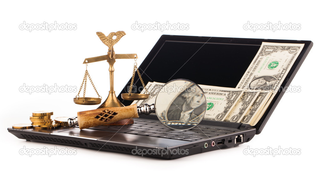 laptop computer keyboard money and magnifying glass