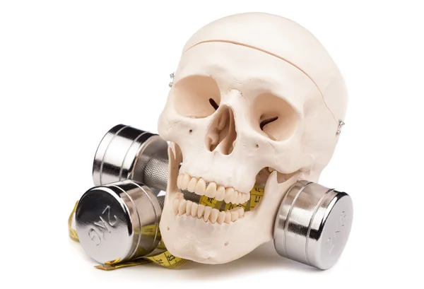 Fitness equipment and human skull isolated on white — Stock Photo, Image