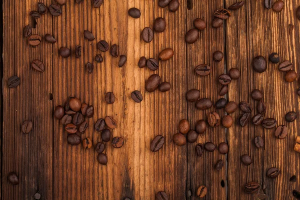 Coffee beans on old table — Stock Photo, Image