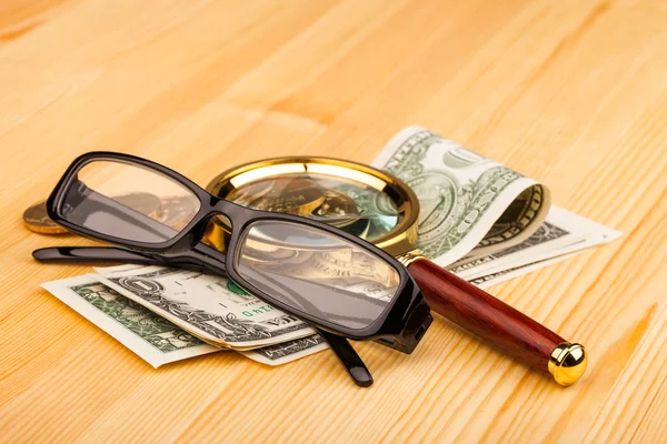 Money and reading glasses — Stock Photo, Image