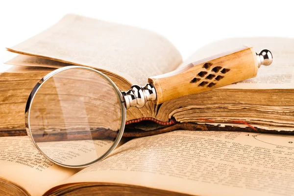 Magnifying glass and old books — Stock Photo, Image