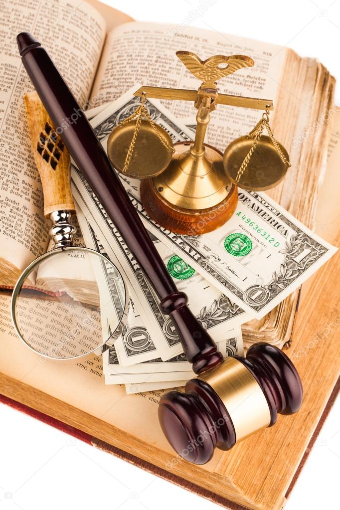 magnifying glass , gavel and old law books