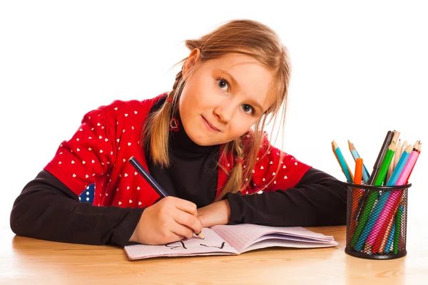 Cute little girl is writing — Stock Photo, Image
