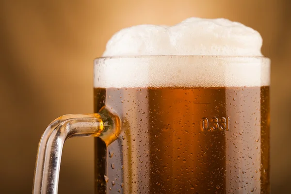 Glass of light beer on table — Stock Photo, Image