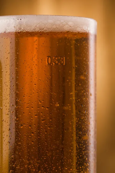 Glass of light beer on table — Stock Photo, Image