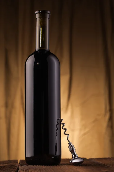 Corkscrew and wine bottle — Stock Photo, Image