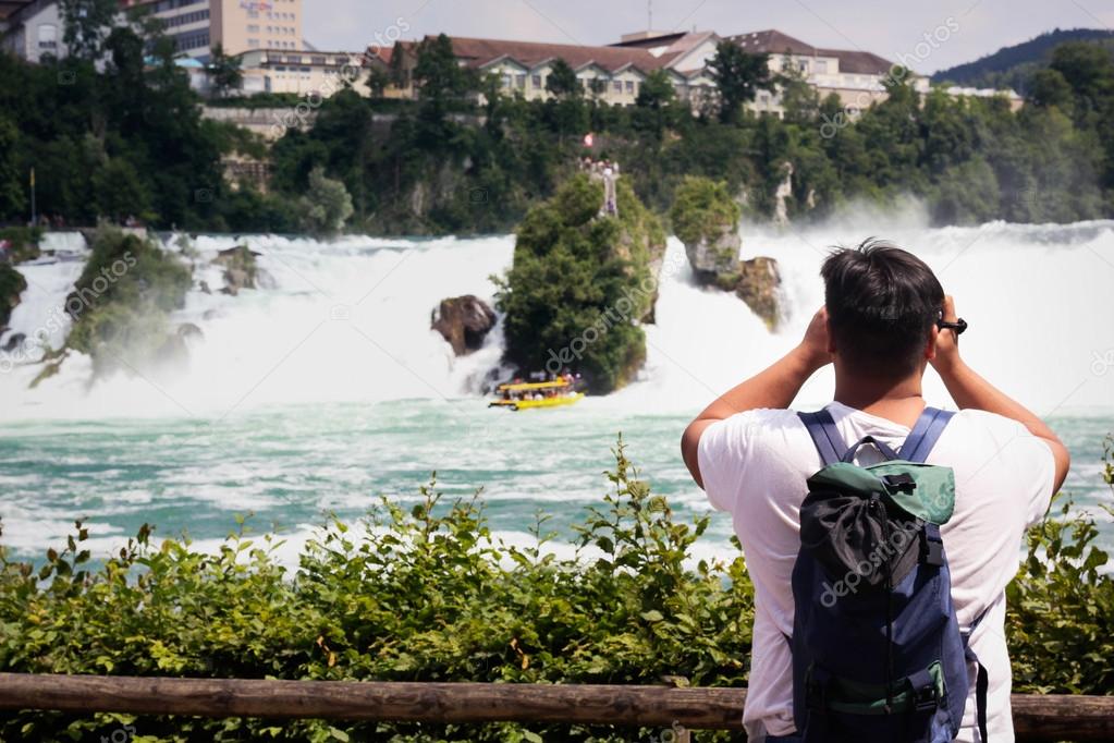 Tourists take pictures of the Rhine Falls in Switzerland