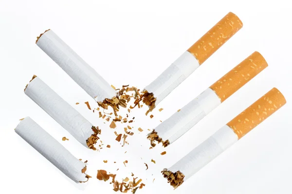 Three broken cigarette on a white background — Stock Photo, Image