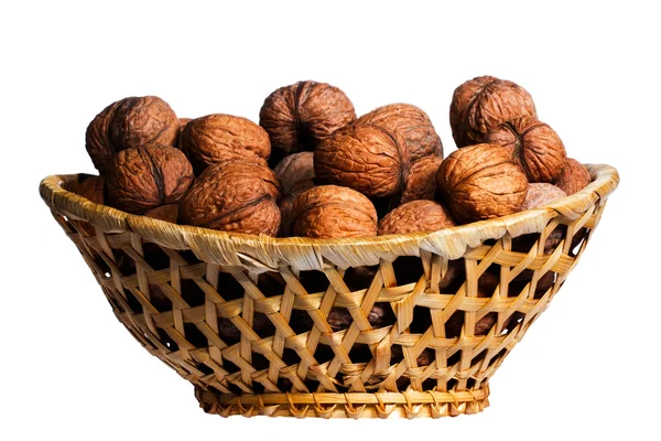 Walnuts in a wicker basket on a white background closeup — Stock Photo, Image