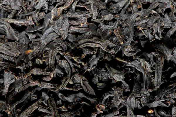 Scattered black tea texture — Stock Photo, Image