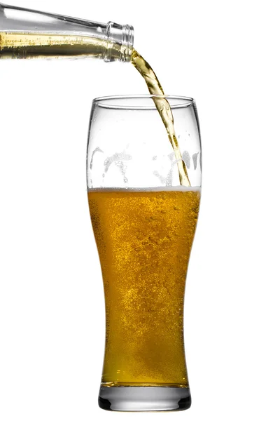 Beer is pouring into glass on white background — Stock Photo, Image