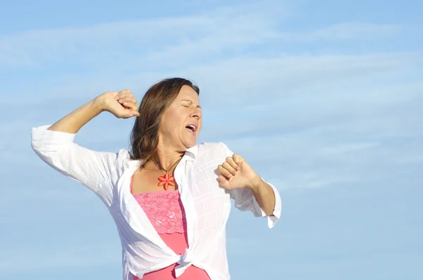 Happy tired woman stretching sky background — Stock Photo, Image