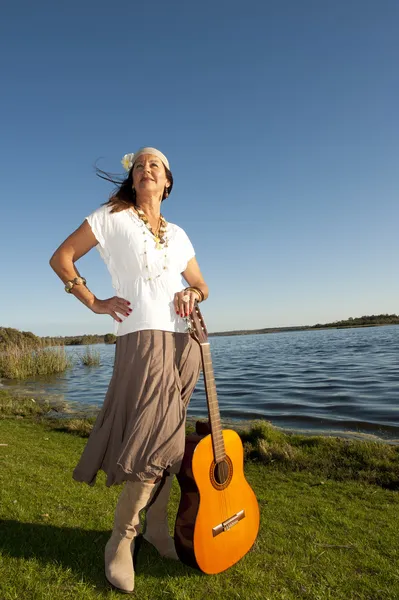 Volwassen hippie vrouw met gitaar — Stockfoto