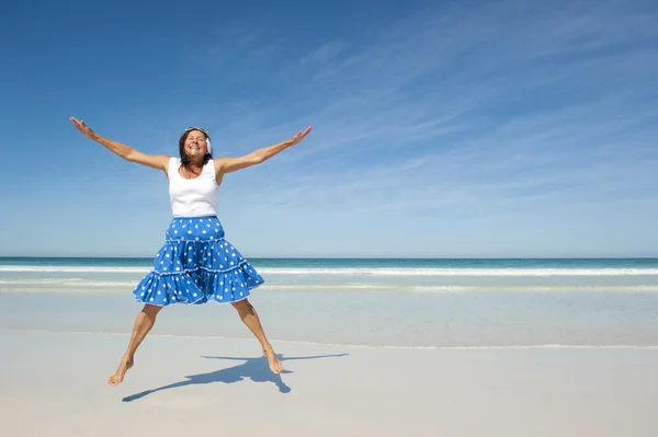 Happy jumping mature woman beach — Stock Photo, Image