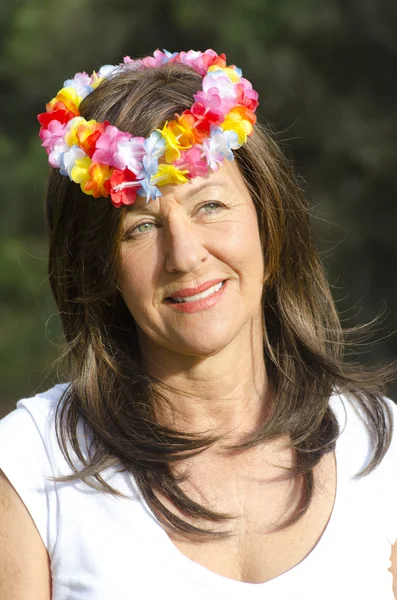 Middle aged woman flower in hair — Stock Photo, Image