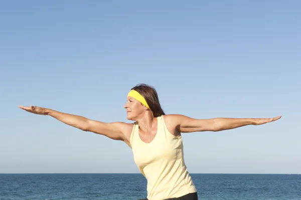 Attractive Senior woman exercising beach — Stock Photo, Image