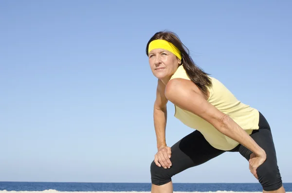 Confident exercising mature woman ocean isolated — Stock Photo, Image