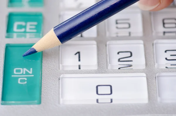 Calculator and pen adding accountant figures — Stock Photo, Image