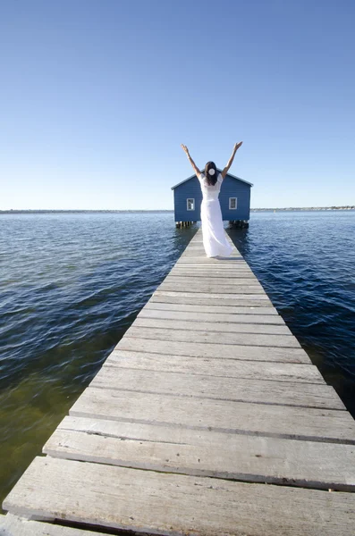 Joyful woman white dress on boardwalk — Stock Photo, Image