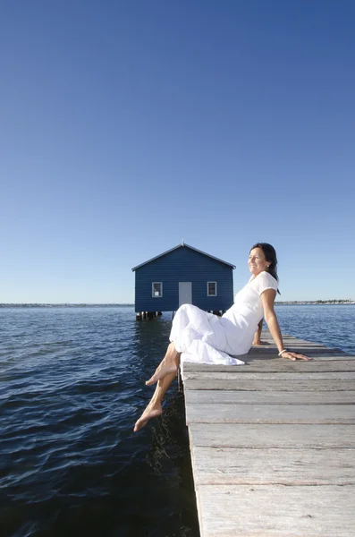 Happy woman white dress on boardwalk at sea — Stock Photo, Image