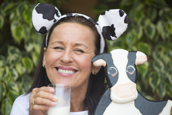 Funny mature woman with milksop and cow